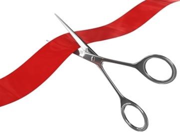 Scissors cutting red tape